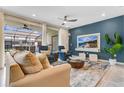 Relaxing living room with a blue accent wall, comfy seating, and a large TV at 3894 Lana Ave, Davenport, FL 33897
