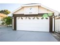 White garage door with decorative windows and dark brown trim at 6632 Meritmoor, Orlando, FL 32818