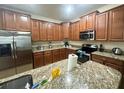 Spacious kitchen with granite countertops and stainless steel appliances at 9030 Shadow Mountain St, Davenport, FL 33896