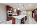 Spacious kitchen with island, stainless steel appliances, and hardwood floors at 9195 Chandler Dr, Groveland, FL 34736