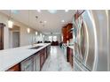 Modern kitchen with stainless steel appliances and wine cooler at 9195 Chandler Dr, Groveland, FL 34736