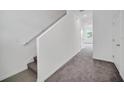 Bright entry hall with staircase and neutral carpeting at 246 Mandovi St, Davenport, FL 33837