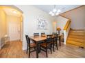 Bright dining room featuring a wooden table and six chairs, adjacent to the entryway at 3520 Calabria Ave # 3520, Davenport, FL 33897