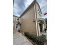 Tan two-story building with garage and landscaping at 6462 Cantua Ln # 105, Orlando, FL 32835