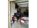 Garage with a car, shelving, and a grill at 6462 Cantua Ln # 105, Orlando, FL 32835