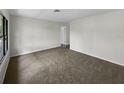 Simple bedroom with neutral carpeting and large window at 6728 Farris Dr, Lakeland, FL 33811