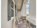 Front porch with rocking chairs and stone accents at 7889 Penrose Pl, Wildwood, FL 34785