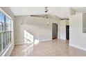 Bright living room with tile floors and vaulted ceiling at 1053 E Hancock Dr, Deltona, FL 32725