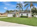 House exterior featuring a garage and landscaping at 1053 E Hancock Dr, Deltona, FL 32725