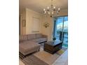 Living room with sectional sofa, coffee table, and pool view at 1144 Challenge Dr, Davenport, FL 33896