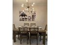 Bright dining room with modern chandelier and wall art at 1144 Challenge Dr, Davenport, FL 33896