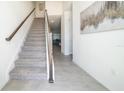 Modern staircase with wood railing and carpeted steps at 1812 Tropical Palms Cir, Kissimmee, FL 34747