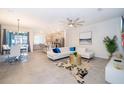 Open-concept living and dining area with modern furniture and tile floors at 1812 Tropical Palms Cir, Kissimmee, FL 34747