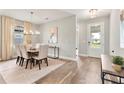 Elegant dining room with hardwood floors, chandelier, and access to foyer at 2094 Derwent Dr, Davenport, FL 33896