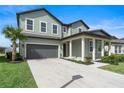 Two story house with gray siding, two car garage and manicured lawn at 2094 Derwent Dr, Davenport, FL 33896