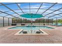 Screened pool area with lounge chairs and umbrella at 2760 Rialto Ct, Kissimmee, FL 34746
