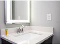 Modern bathroom vanity with illuminated mirror and chrome fixtures at 4410 Le Reve Ct, Kissimmee, FL 34746