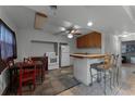 Kitchen features wood cabinets, tiled floors, and breakfast bar at 4908 Seminole Ave, Winter Park, FL 32792