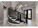 Elegant curved staircase with wrought iron railings at 8528 Adalina Pl, Orlando, FL 32827