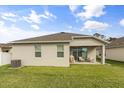Covered patio and spacious backyard with great lawn space at 1554 Outback W Rd, St Cloud, FL 34771