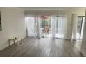 Living room with grey vinyl plank flooring and access to deck at 4559 Tower Pine Rd # Ge, Orlando, FL 32839