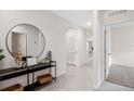 Bright and airy entryway with tile flooring, console table, and large mirror at 1258 Limbali St, Mount Dora, FL 32757