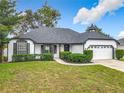 Beautiful house with gray roof, white exterior, and well-manicured lawn at 1452 3Rd Ave, Deland, FL 32724