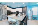 Modern kitchen with island, stainless steel appliances, and painted ceiling at 2734 Oxymoron Way, Kissimmee, FL 34746