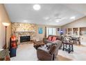 Spacious living room with stone fireplace and adjacent dining area at 653 Pelican Bay Dr, Daytona Beach, FL 32119