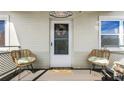 Inviting front porch with wicker chairs and a beach-themed welcome sign at 131 Mitchell Pl, Daytona Beach, FL 32118