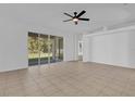 Bright living room with tile flooring and sliding glass doors leading to backyard at 3211 Eagle Watch Dr, Kissimmee, FL 34746