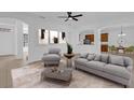 Spacious living room with gray sofa and chairs, coffee table, and view to kitchen at 3211 Eagle Watch Dr, Kissimmee, FL 34746