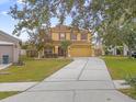 Two-story house with yellow exterior and brown roof at 1161 Cathcart Cir, Sanford, FL 32771