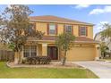 Two-story house with yellow exterior and brown roof at 1161 Cathcart Cir, Sanford, FL 32771