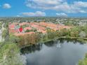 Aerial view of a townhome community near a lake at 1938 Michael Tiago Cir, Maitland, FL 32751