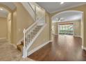 Bright entryway with hardwood floors and staircase at 1938 Michael Tiago Cir, Maitland, FL 32751