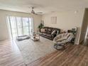 Living room with a leather couch, a chair, and wood-look flooring at 3053 George Mason Ave # D, Winter Park, FL 32792