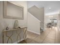 Bright entryway with gold console table and mirror at 8962 Cuban Palm Rd, Kissimmee, FL 34747