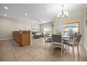 Open concept kitchen and dining area with granite countertops and stainless steel appliances at 8962 Cuban Palm Rd, Kissimmee, FL 34747