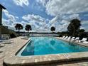 Community pool with lounge chairs and lake view at 902 Lake Destiny Rd # A, Altamonte Springs, FL 32714