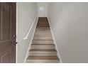 Indoor view of wooden staircase with simple railing at 14304 Fredricksburg Dr # 420, Orlando, FL 32837