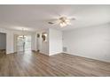 Bright living room with light wood floors and ceiling fan at 2788 Privada Dr, The Villages, FL 32162