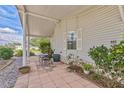 Relaxing covered patio with seating area, perfect for outdoor enjoyment at 905 Polo Park Blvd, Davenport, FL 33897
