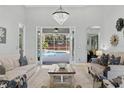 Living room with sofas, coffee table, and view of pool at 9810 Camberley Cir, Orlando, FL 32836