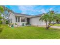 White single story home with attached garage, landscaping, and driveway at 821 Pine Shores Cir, New Smyrna Beach, FL 32168