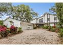 Two-story home with stone accents and a paver driveway at 9792 Wild Oak Dr, Windermere, FL 34786