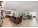 Kitchen with large island, granite countertops, dark brown cabinets and stainless steel appliances at 1989 Marsh Hen Vlg, Deland, FL 32720