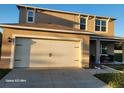Two-story house with attached garage and landscaping at 2582 Glacier Express Ln, Tavares, FL 32778
