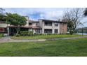 Two-story condo building with grassy lawn and walkway at 4641 Cason Cove Dr # 2124, Orlando, FL 32811