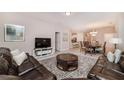 Open living space with comfortable seating and view into dining area at 5160 Oakbourne Ave, Davenport, FL 33837